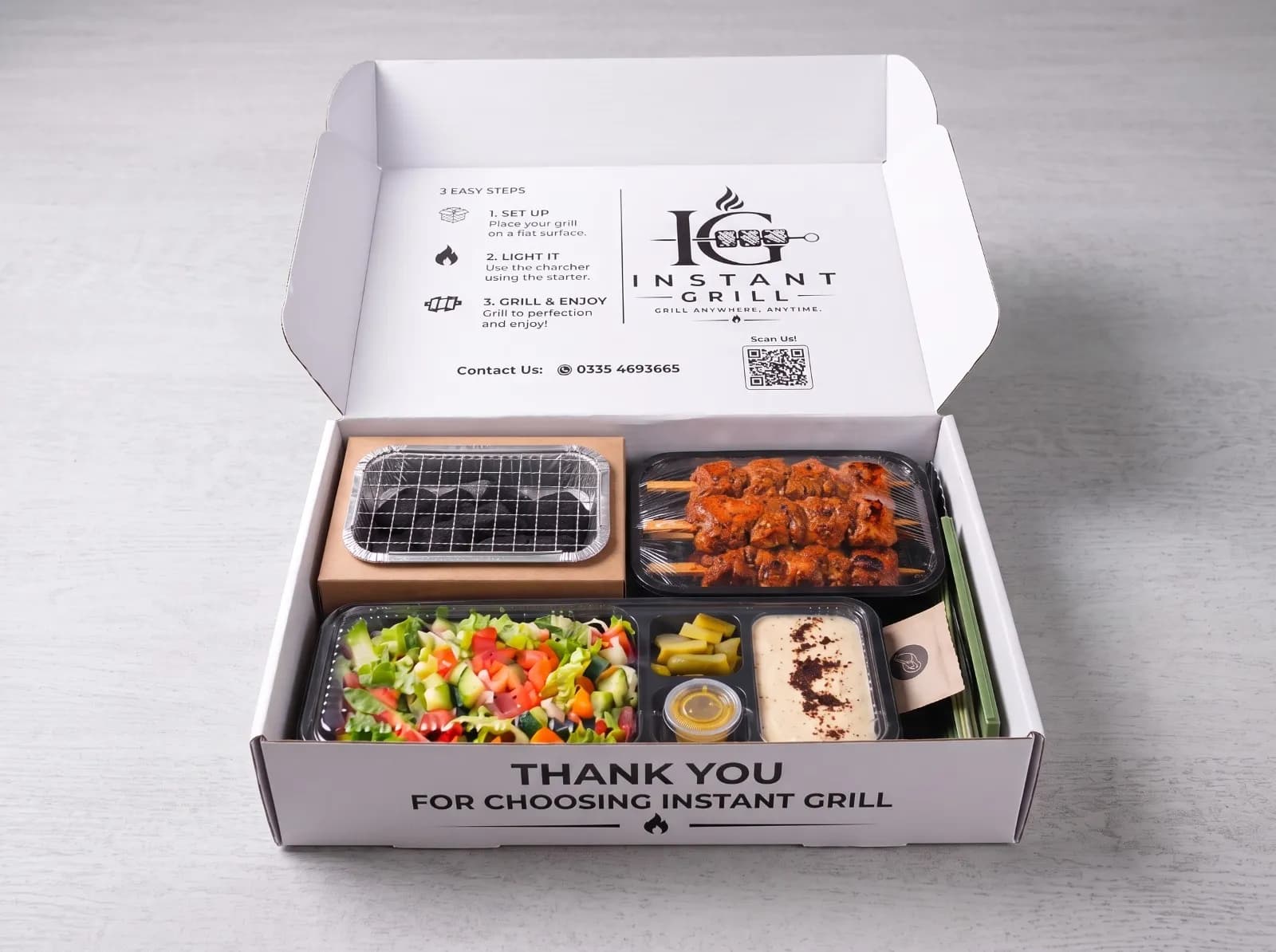 Open Instant Grill box with chicken tikka on the grill